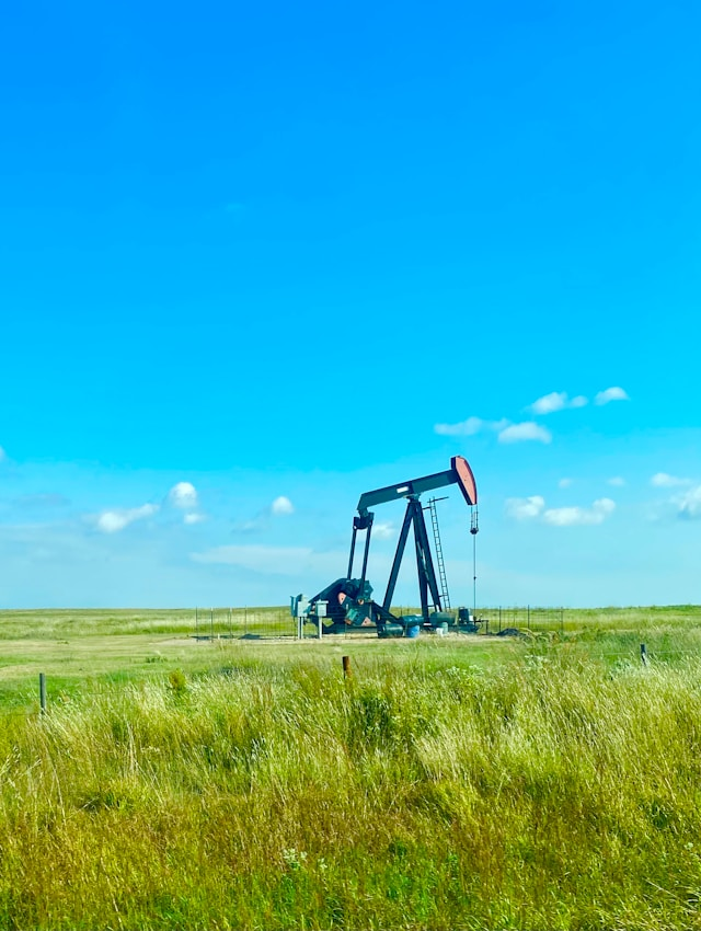 oiljack oiljack in a nice open green field and a clear blue sky